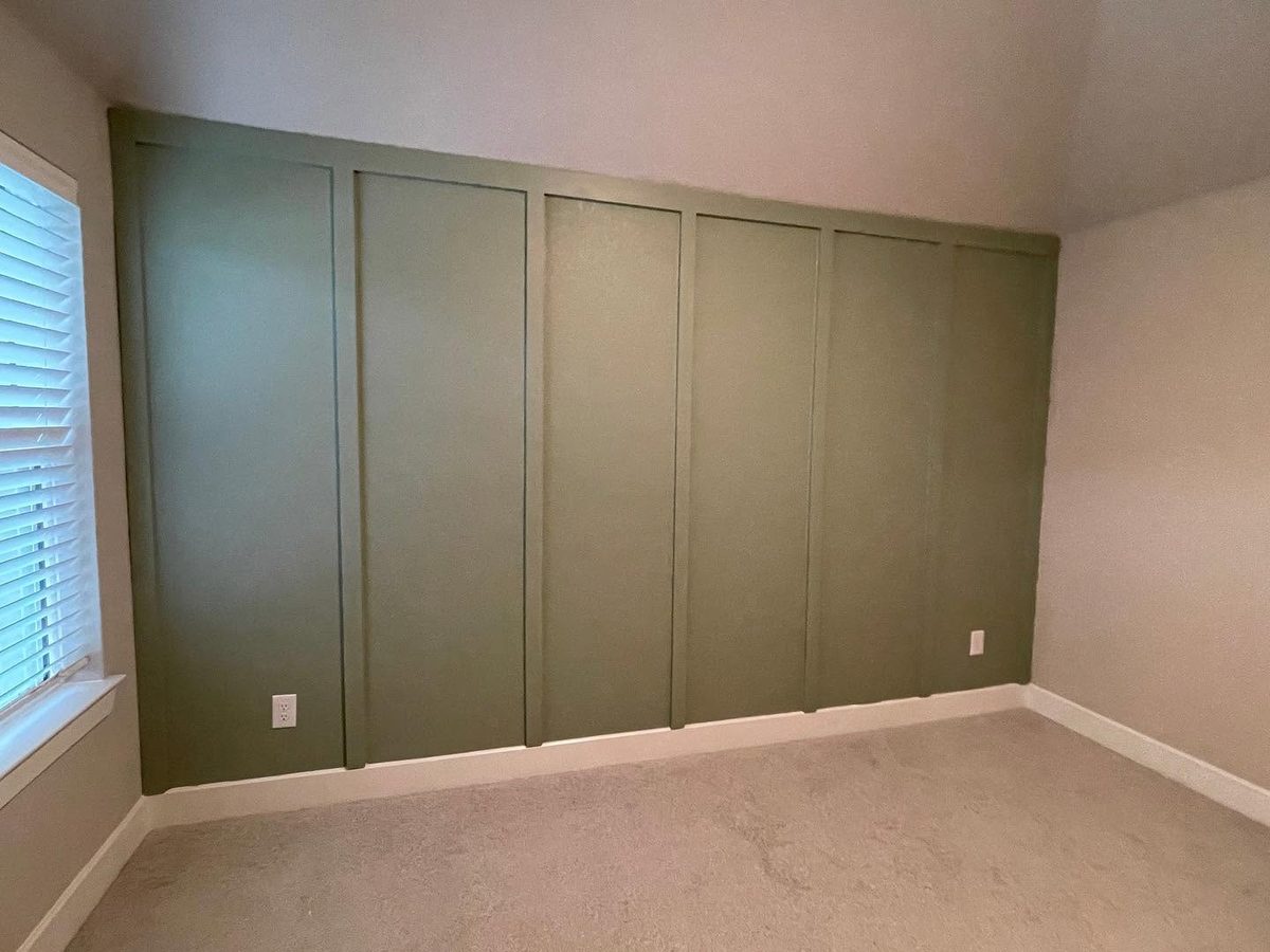 After: the accent wall painted sage green